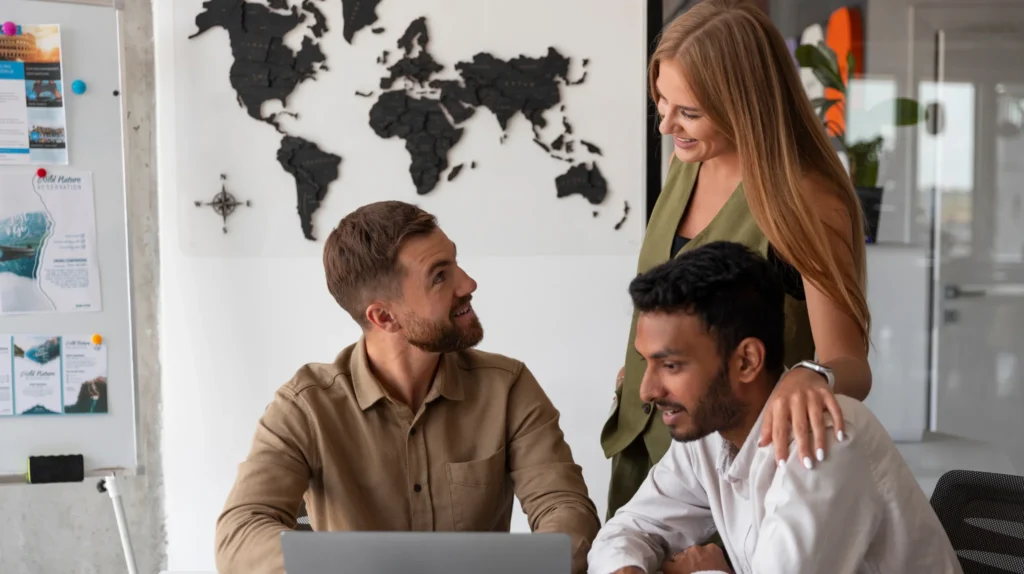 A team of marketers work on a laptop